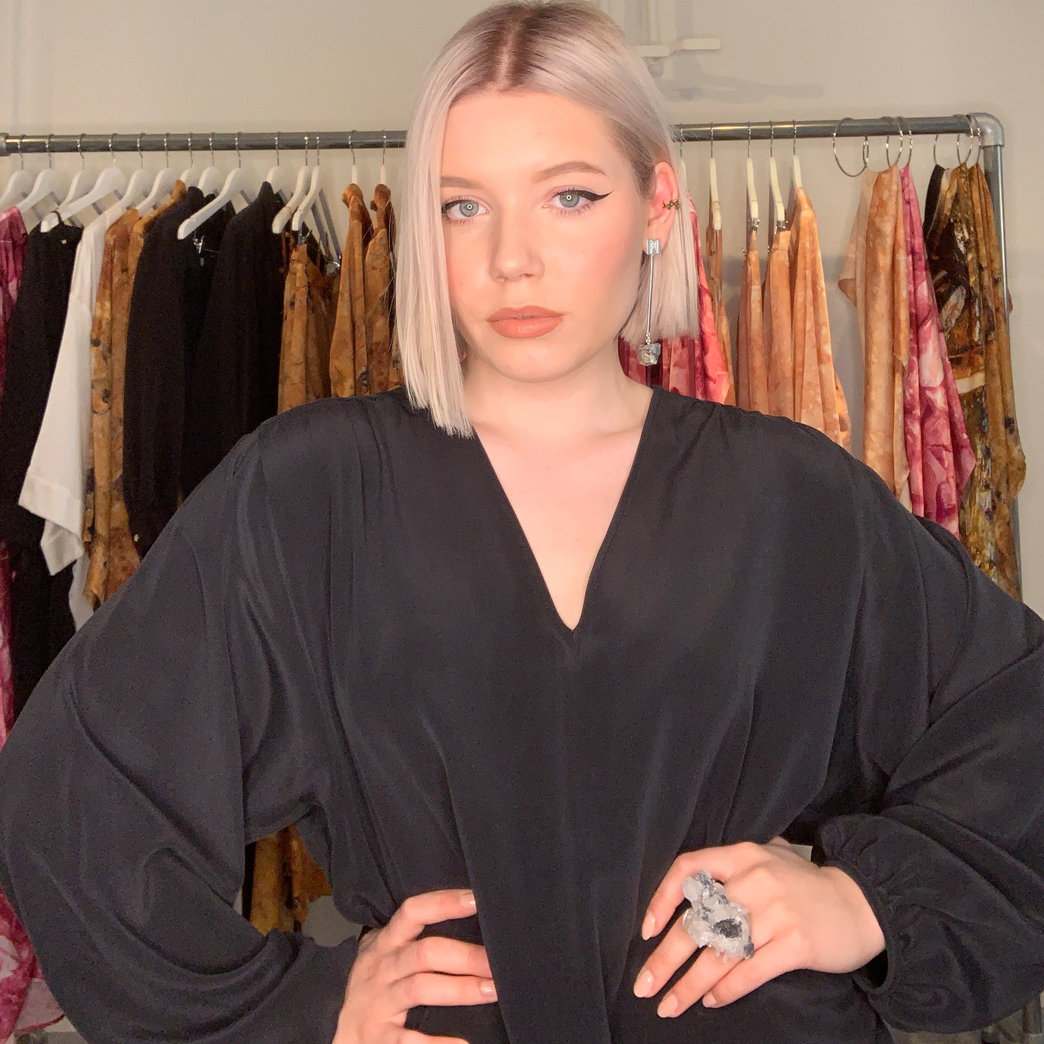 Model in fashion studio wearing Art Ring Special Edition Quartz by Märta Larsson. Statement ring styled with voluminous sleeves and layered earrings — perfect for artistic styling.