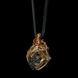 Bondage Pyrite Gold Pendant Necklace by Märta Larsson featuring a metallic pyrite crystal wrapped in gold wire on a black leather cord.