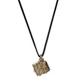 Close-up of the Bondage Pyrite Silver Pendant Necklace by Märta Larsson featuring a raw pyrite crystal in a silver wire cage.