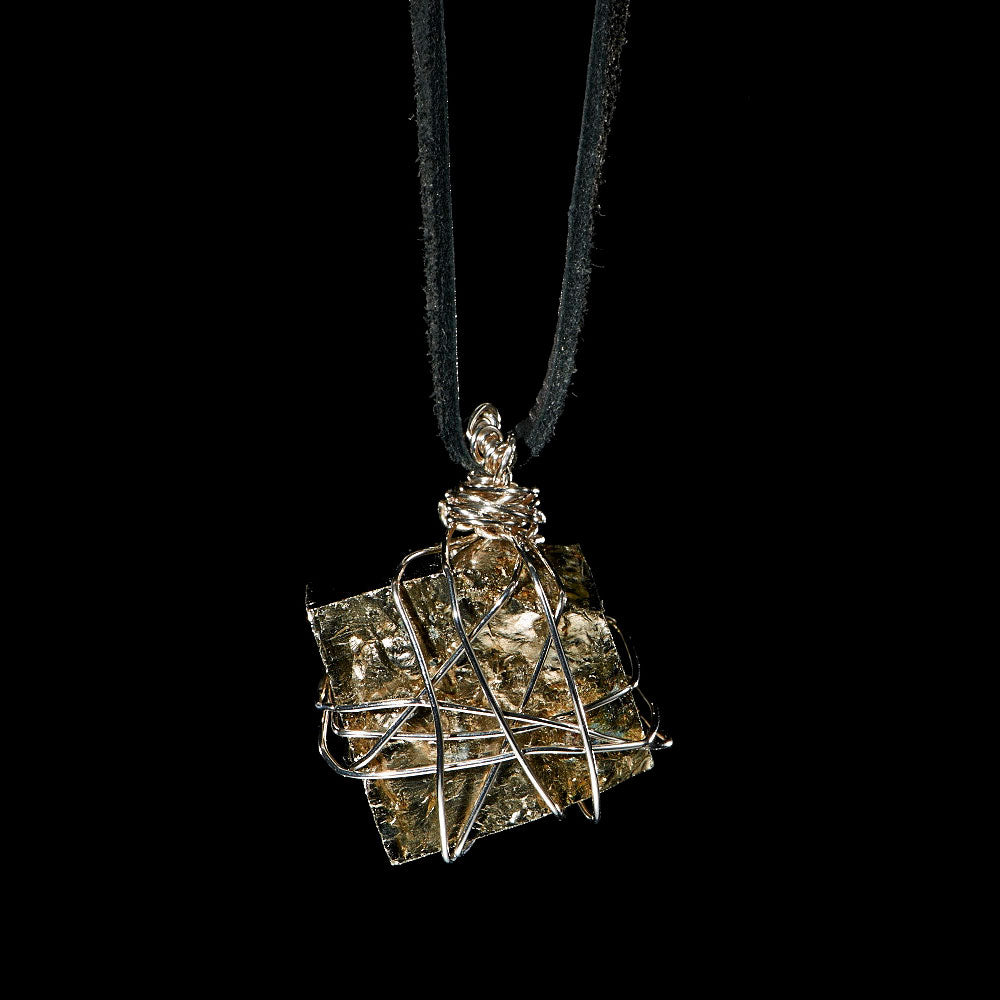 Bondage Pyrite Silver Pendant Necklace by Märta Larsson featuring a raw metallic pyrite crystal wrapped in silver wire on a black leather cord.