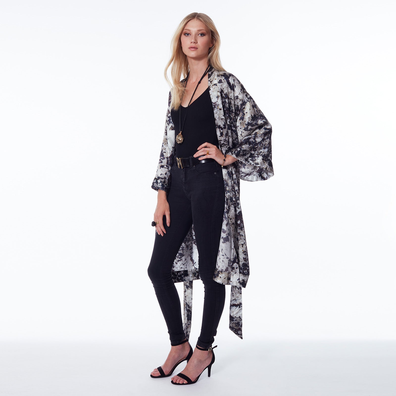 Model wearing the Bondage Pyrite Silver Pendant Necklace by Märta Larsson with a patterned kimono and layered jewelry, styled for bold expressive fashion.