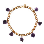 Collar Amethyst Necklace by Märta Larsson featuring seven raw purple amethyst stones on a gold-plated collar chain, bold and sculptural.