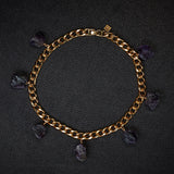  Collar Amethyst Bracelet by Märta Larsson laid out on black textured surface. Gold bracelet with raw amethyst charms — elegant, expressive, and naturally powerful.
