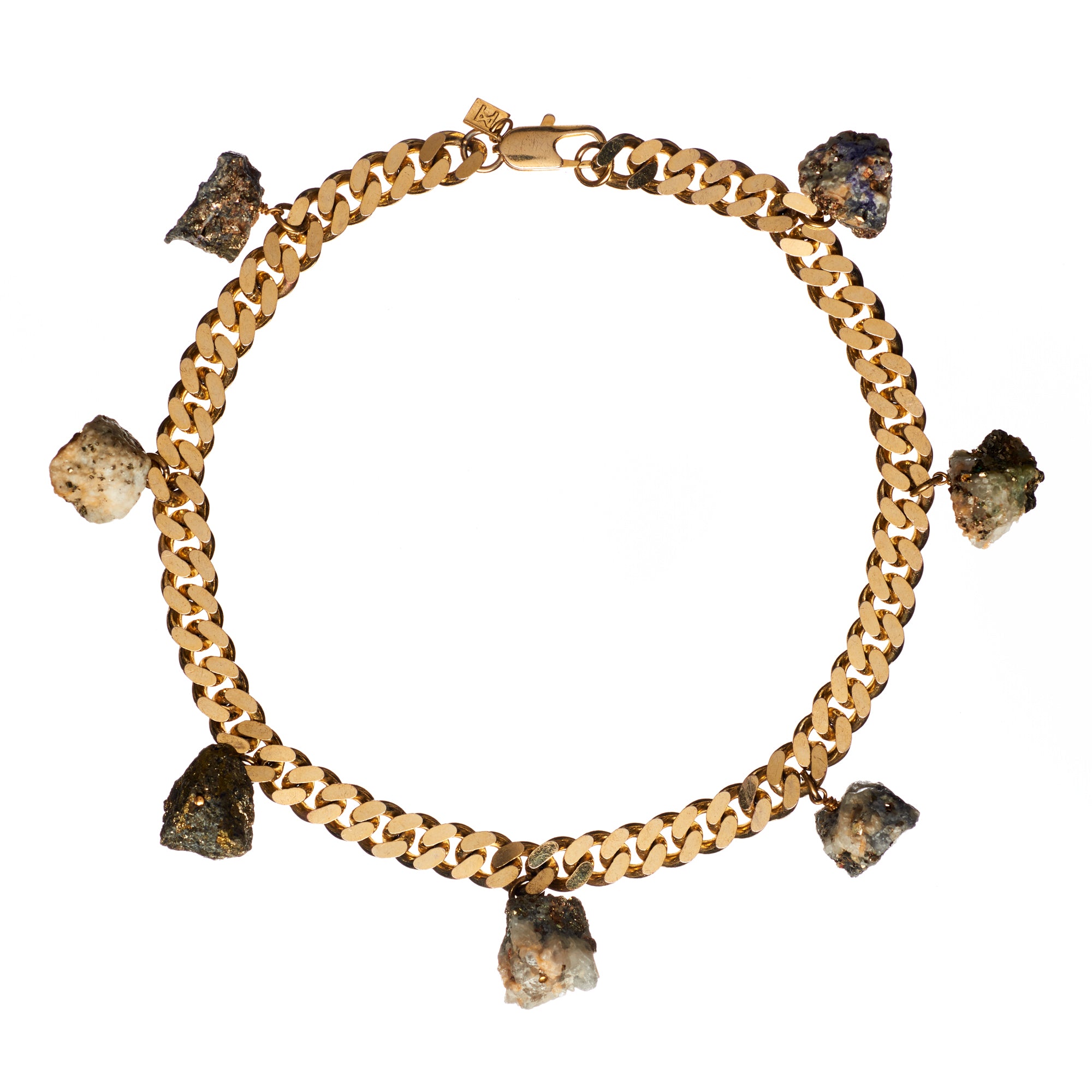 Collar Calcite Pyrite Necklace by Märta Larsson featuring seven raw calcite-pyrite stone charms on a gold-plated chain, bold and handcrafted.