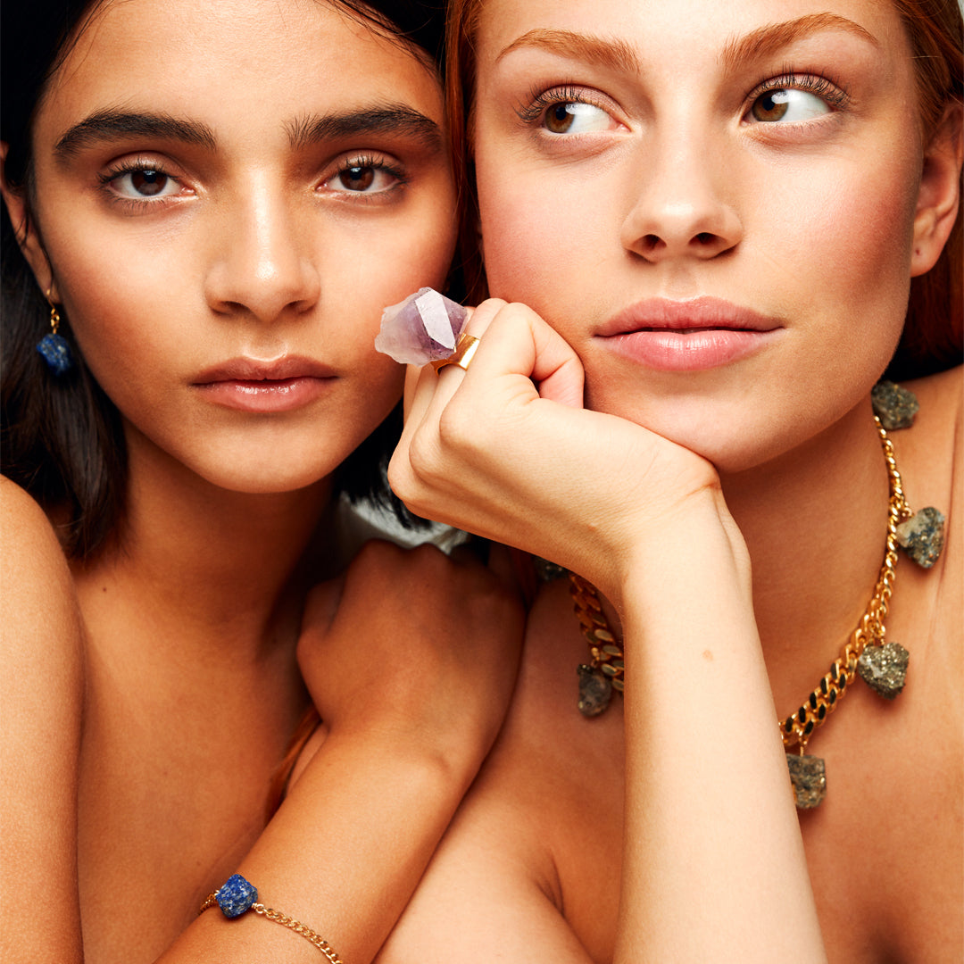 Model wearing Collar Calcite Pyrite Necklace by Märta Larsson with layered gemstone jewelry. Raw pyrite necklace styled for expressive elegance and natural edge.