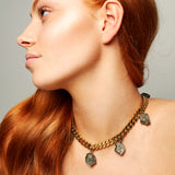 Model wearing the Collar Pyrite Necklace by Märta Larsson with red hair and minimalist styling, a raw pyrite statement piece for confident elegance.