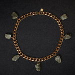 Collar Pyrite Necklace by Märta Larsson laid out on black textured surface. Gold collar necklace with raw pyrite stones — edgy, refined, and handcrafted.
