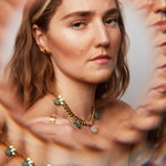 Model wearing the Collar Ruby Zoisite Necklace by Märta Larsson with kaleidoscopic reflections, a raw gemstone piece styled for expressive elegance.