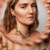 Model wearing the Collar Ruby Zoisite Necklace by Märta Larsson with kaleidoscopic reflections, a raw gemstone piece styled for expressive elegance.