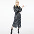 Front view of a model wearing the Glam Rock Silk Satin Shirt Dress by Märta Larsson, photographed against a white background. This oversized satin shirt dress features a button-through front, crisp collar, and relaxed fit — a bold fashion dress for women perfect for luxury styling and modern rock & roll flair.