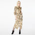 Model wearing the Glam Rock Silk Satin Shirt Dress by Märta Larsson, photographed from the front against a white background. This oversized satin shirt dress features a relaxed fit, button-through front, and crisp collar — a bold fashion dress for women perfect for luxury styling and modern rock & roll flair.