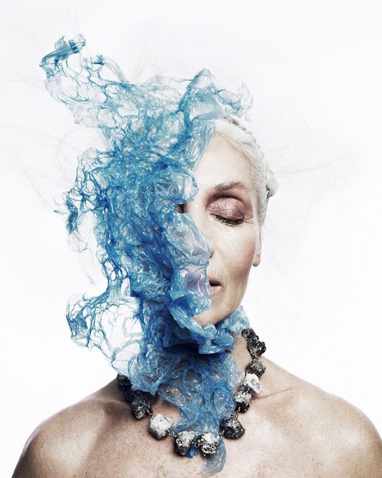 Model wearing the Not a Pearl Necklace Calcite Pyrite by Märta Larsson with a surreal blue overlay, styled for artistic power and expressive fashion.