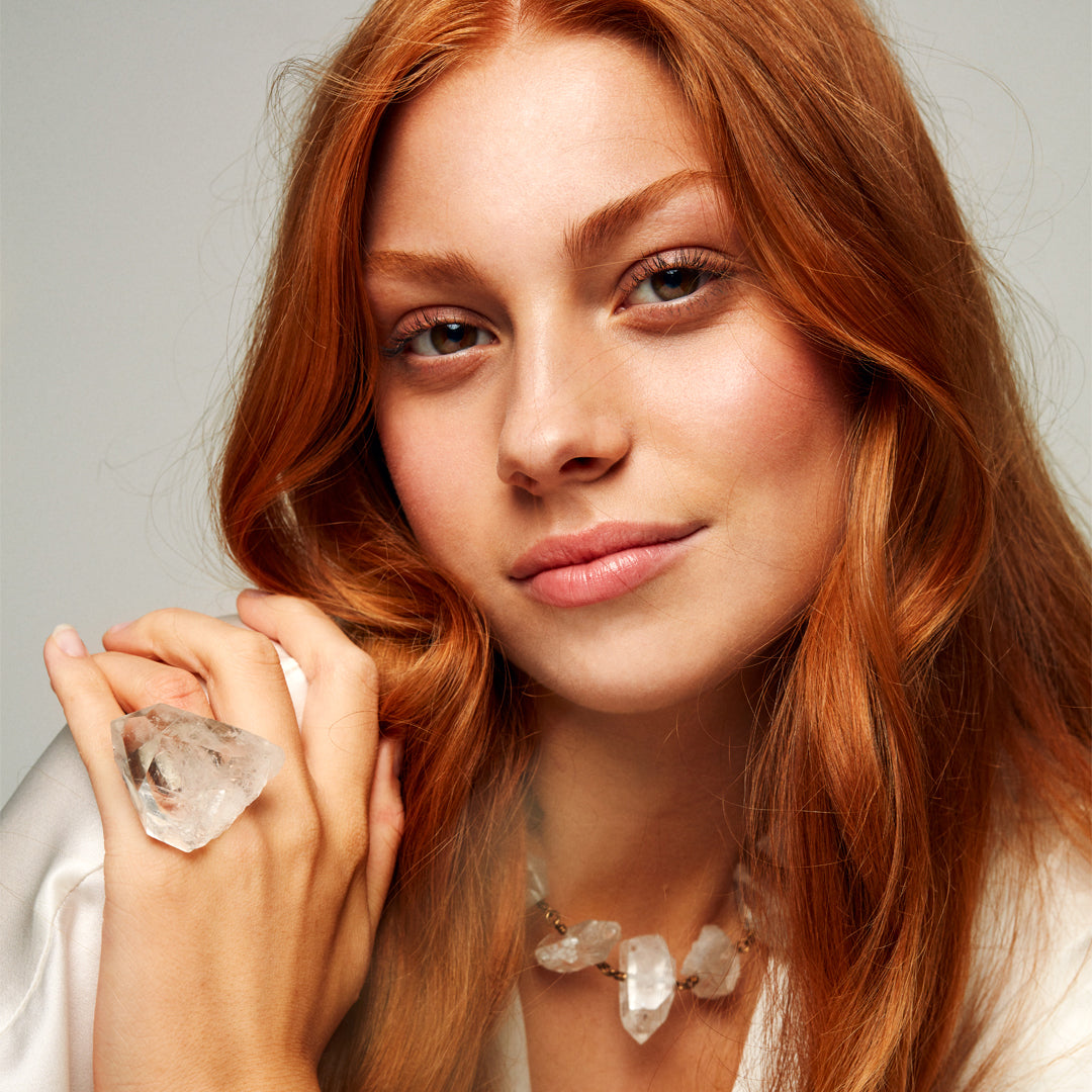 Model wearing the Not a Pearl Necklace Rough Quartz Point by Märta Larsson with red hair and a white top, styled for ethereal crystal elegance.