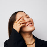 Model with hand partly covering her face wearing the bold, raw and sophisticated Märta Larsson Power Ring, a crystal gold-vermeil statement ring on the index finge