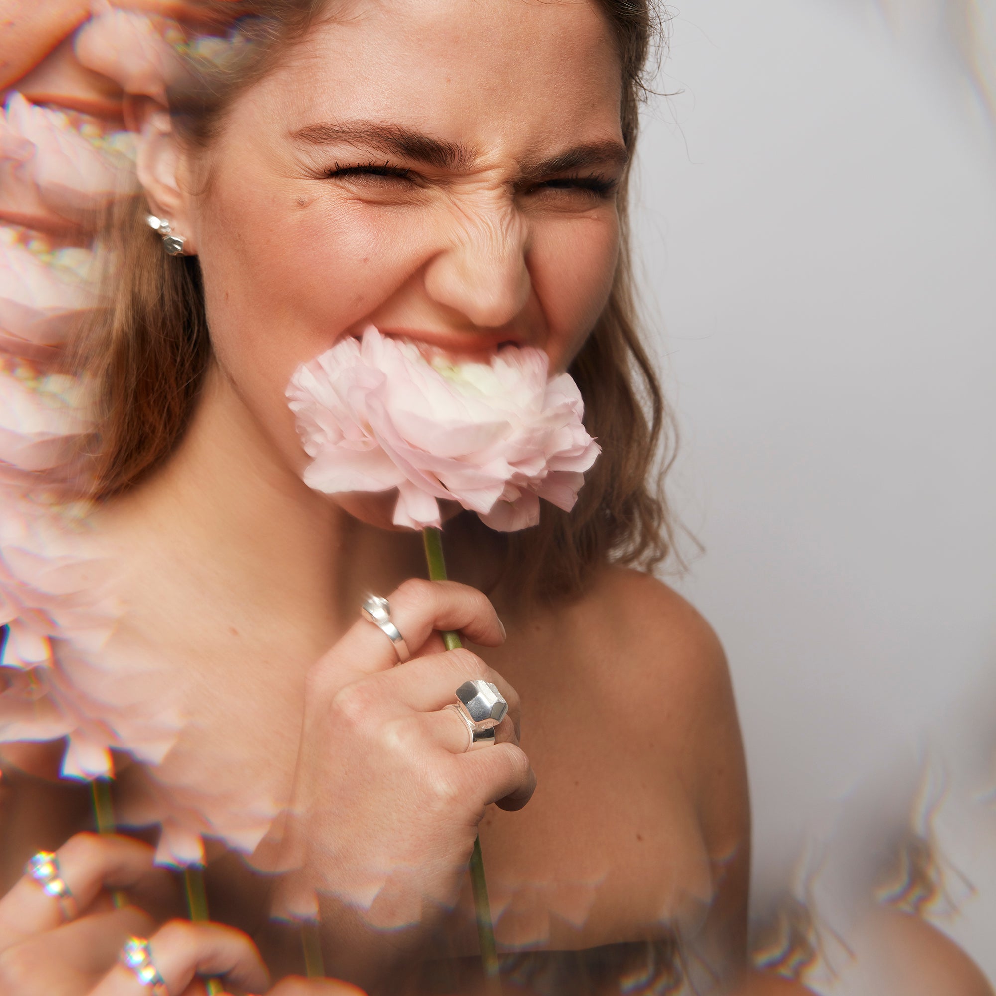  Playful pose with Power Ring and silver jewelry, highlighting geometric shapes and bold personal expression.
