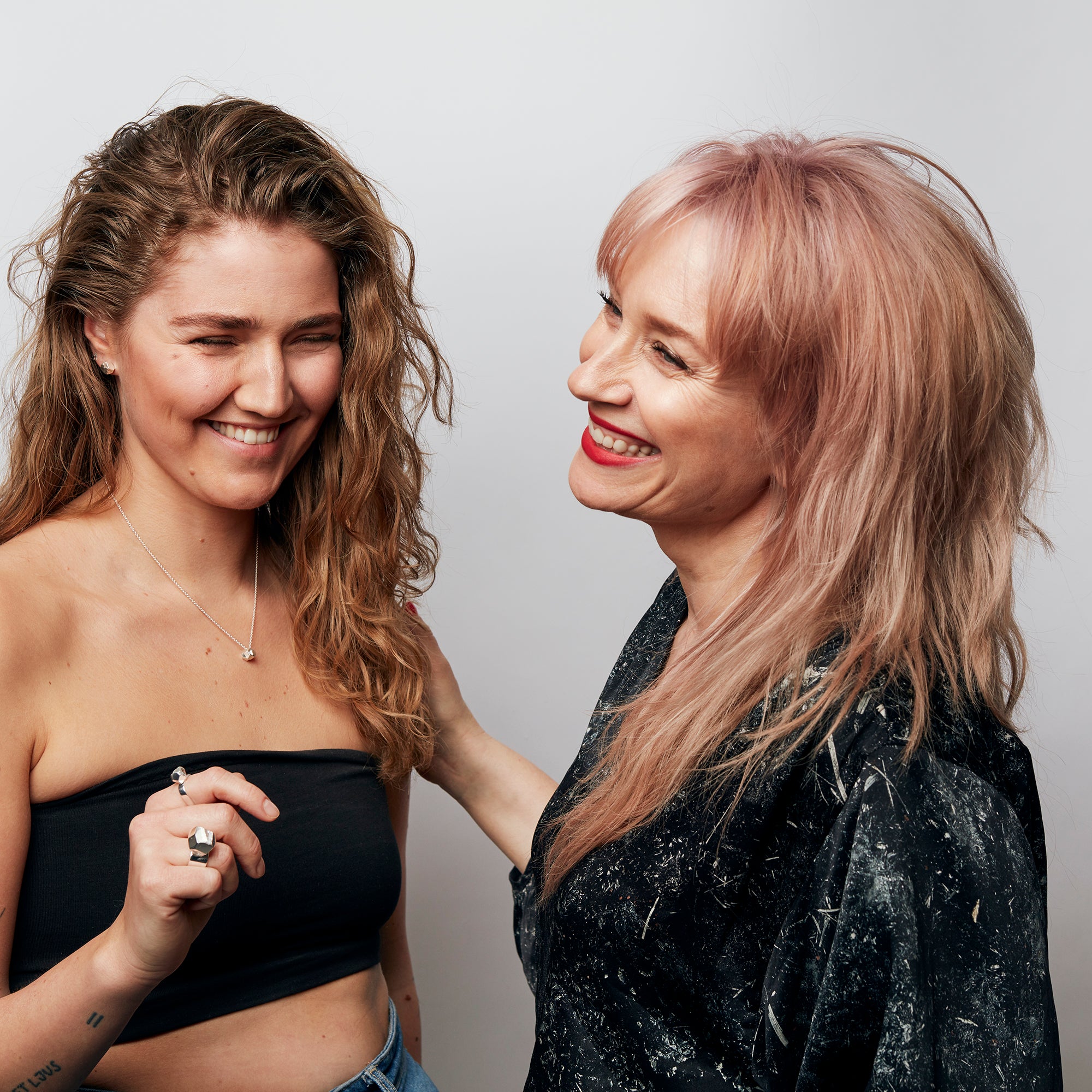 Model wearing the Rolling Stone Necklace by Märta Larsson with voluminous hair, a raw crystal silver piece styled for minimalist modern elegance.