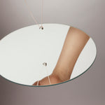 Rolling Stone Necklace by Märta Larsson reflected in a mirror, a recycled silver piece with a small geometric sculptural pendant.