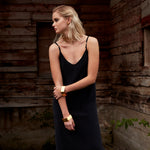 Model in black dress wearing the Gold Chain Belt & Necklace by Märta Larsson, a polished gold chain styled with layered jewelry.