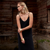 Model in black dress wearing the Gold Chain Belt & Necklace by Märta Larsson, a polished gold chain styled with layered jewelry.