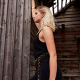Gold Chain Belt & Necklace by Märta Larsson shown against rustic wood, a bold convertible gold chain styled with a black outfit.