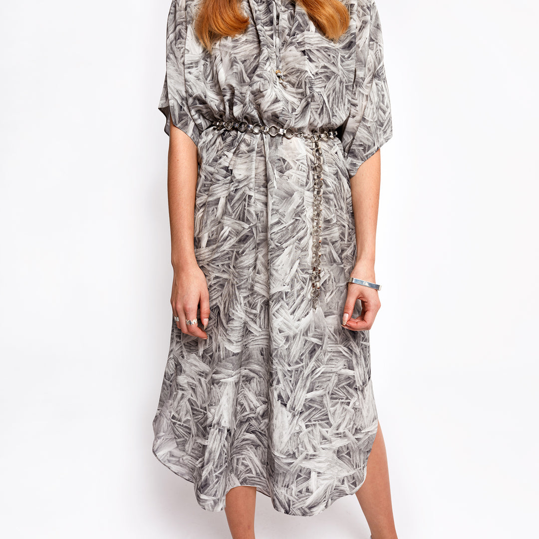 Signature Silver Chain Belt & Necklace by Märta Larsson worn with an abstract-patterned dress, an adjustable polished silver chain styled as a bold, versatile belt.