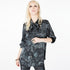 Front view of a model wearing the Boyfriend Silk Satin Shirt by Märta Larsson, photographed against a white background. This relaxed-fit shirt in 100% silk satin features a boyish collar and pocket, offering a laid-back luxury look ideal for pairing with mens fashion jewelry or designer mens jewellery.
