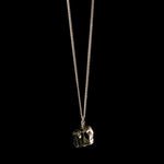 Close-up of The Raw One Shiny Pyrite Necklace by Märta Larsson, a raw metallic pyrite pendant styled for modern elegance and everyday impact.