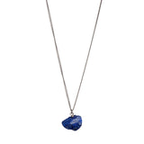 The Raw One Lapis Lazuli Necklace by Märta Larsson in silver with a rough blue crystal pendant, a minimalist naturally radiant piece.