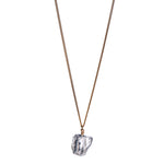 The Raw One Rough Quartz Necklace by Märta Larsson with raw clear quartz on a gold chain, a handcrafted crystal piece with natural clarity.