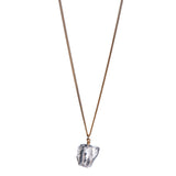 The Raw One Rough Quartz Necklace by Märta Larsson with raw clear quartz on a gold chain, a handcrafted crystal piece with natural clarity.
