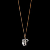 The Raw One Rough Quartz Necklace by Märta Larsson on black background, a gold-vermeil chain with raw clear quartz for bold frozen-light contrast.