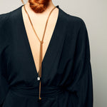 Back view of model wearing the Tie Me Up Black Tourmaline Necklace by Märta Larsson, a raw tourmaline lariat with gold accents for dramatic style.